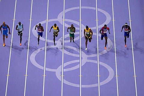 Athletes compete in the men's 100-meter final